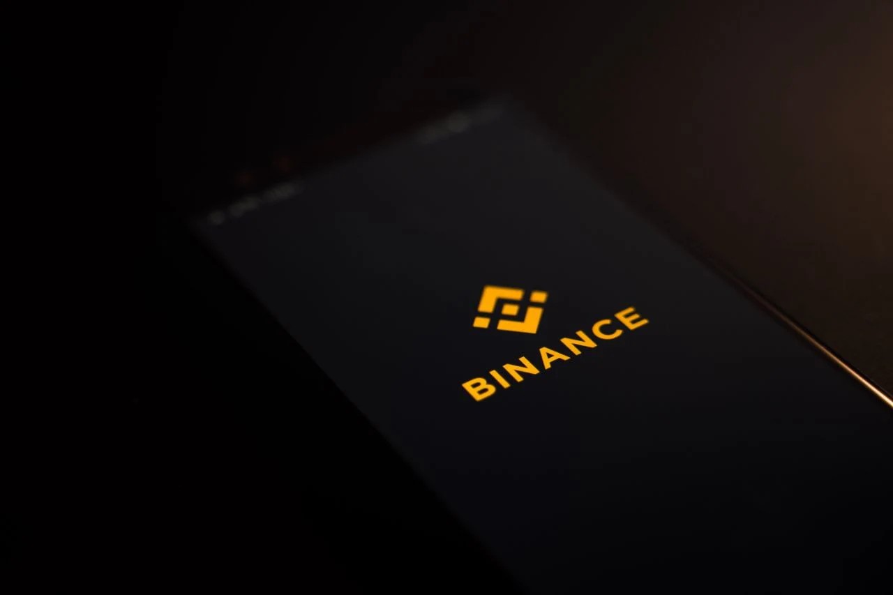A phone in which Binance app is opened, dark background