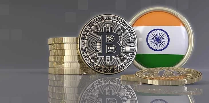 Bitcoin logo and Indian flag logo in a coin