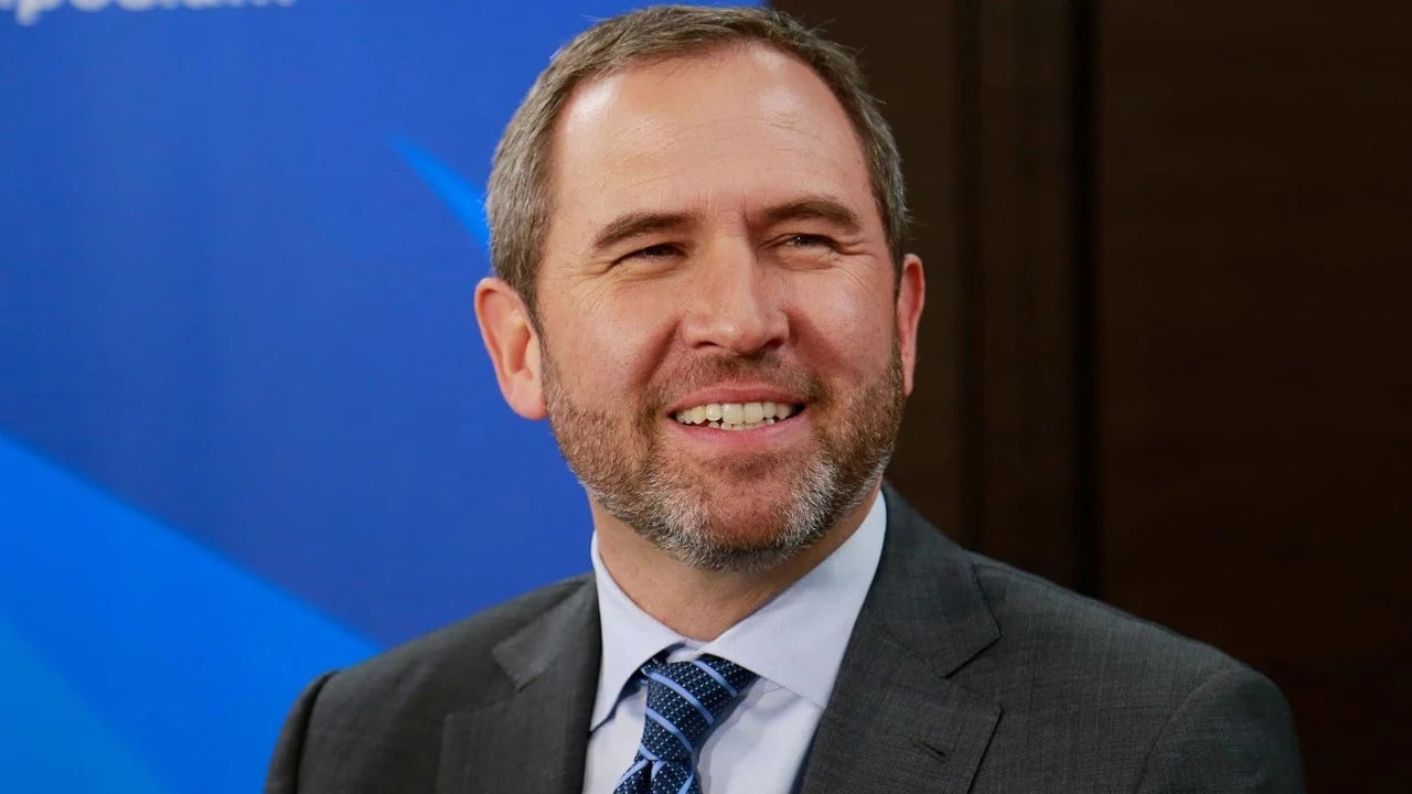 The CEO of Ripple, Brad Garlinghouse wearing tie and gray suit