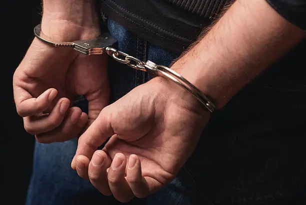 Image of a handcuffed man