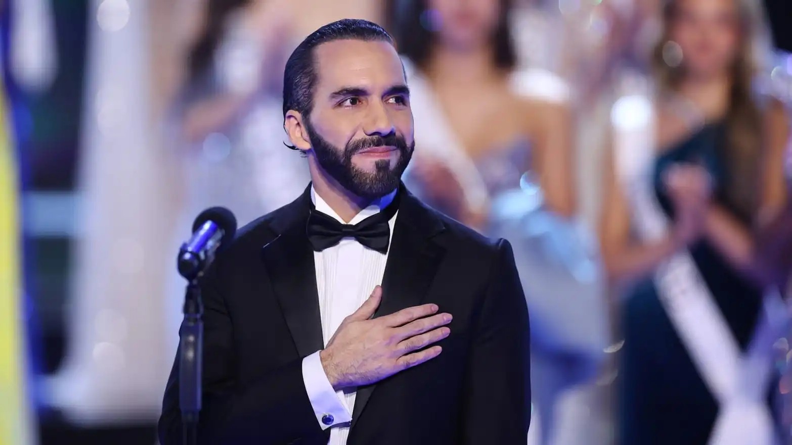 Image of Nayib Bukele wearing black coat and celebrating his re-election victory in El Salvador