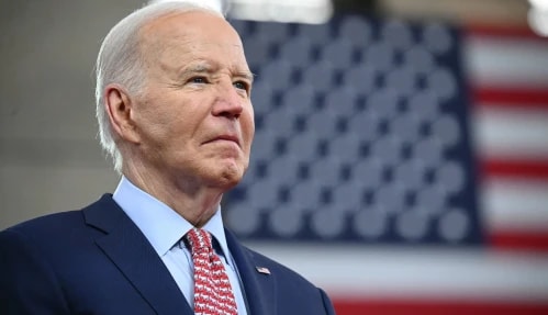 Joe Biden standing in front of US Flag