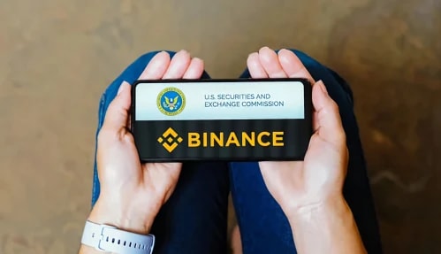 Binance and The SEC logo in a phone