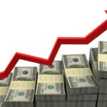 A pile of cash with an arrow going upward