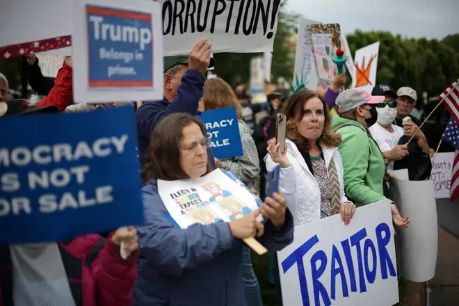 Protesters during the TRUMP memecoin dinner